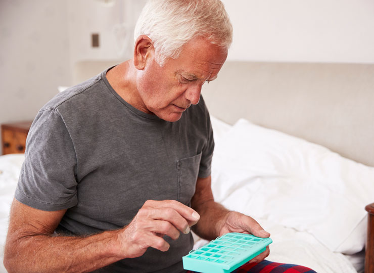 Senior Man taking pills