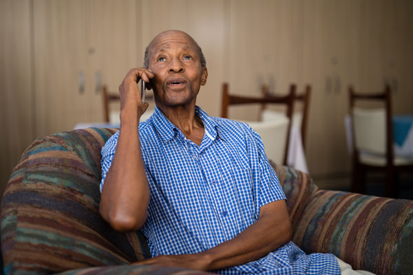 Elderly black man on telephone, looks like memory loss - age related forgetfulness