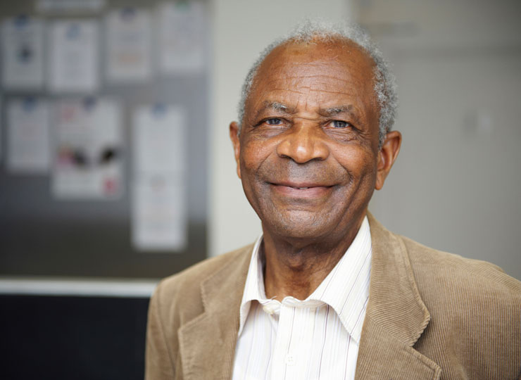 Elderly black man smiling and looking at the camera