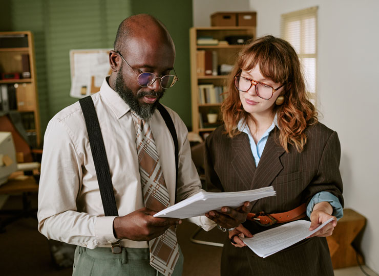 Two professional colleagues reviewing documents together in an office